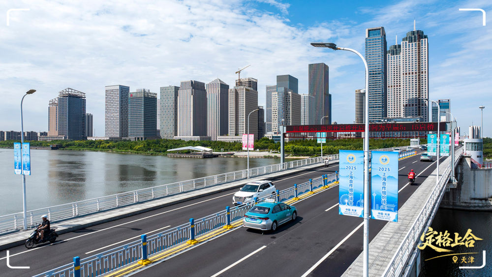 在天津市濱海新區,道路旁的路燈上懸掛著“2025上海合作組織峰會”等標識。
